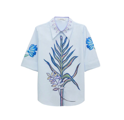 The Floral Embrace Blouse by Dorothee Schumacher is a light blue classic shirt with a botanical key print on the front and blue floral details on the sleeves and collar.