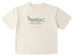 The Rylee & Cru Baby Boys' and Boys' Relaxed Tee is a beige cotton jersey shirt with a cartoon crocodile and “Surfs Up!” text, offering a comfortable fit for easy dressing.