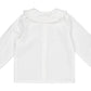 The Kidiwi Baby Girls' Hélena Blouse features navy embroidery, long sleeves, a ruffled Peter Pan collar, and buttoned cuffs, styled in off-white plumetis and shown flat on a white background.