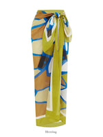 A Soleil Soleil Square Pareo with a vibrant, abstract pattern in shades of green, blue, brown, and white. Made from organic cotton, it features a knot tie at the waist. Perfect as a beach cover-up or long skirt. The word "Herring" is written below the pareo.

Brand: Soleil Soleil