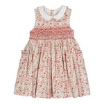 The Kidiwi Baby Girls' and Girls' Ixia Smocked Dress features a sleeveless cotton floral design in cherry red and green with a white Peter Pan collar, smocked bodice, and side pockets—ideal as a charming summer dress.