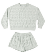 The Rylee & Cru Baby Girls' and Girls' Karli Set is a light green terry cloth outfit featuring a textured sweatshirt and matching shorts with an allover raised shell pattern.