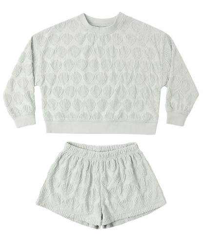 The Rylee & Cru Baby Girls' and Girls' Karli Set is a light green terry cloth outfit featuring a textured sweatshirt and matching shorts with an allover raised shell pattern.