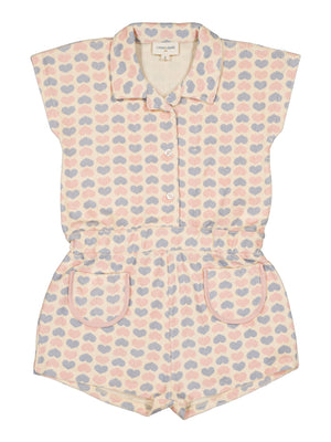 Girls’ Lola Terry Heart Overall by Louis Louise: a short-sleeve terrycloth romper featuring a collar, button front, and pockets, adorned with pastel pink, blue, and beige hearts on textured fabric.