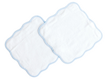 Two rectangular white wash cloths from Terry Tots, featuring scalloped blue-trimmed edges, are layered together on a white background—providing everyday luxury and gentle cleansing as part of the Wash Cloth Set for your daily routine.