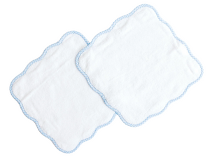 Two rectangular white wash cloths from Terry Tots, featuring scalloped blue-trimmed edges, are layered together on a white background—providing everyday luxury and gentle cleansing as part of the Wash Cloth Set for your daily routine.