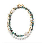 The Porto Covo Necklace by Lizzie Fortunato features gold-plated chain links, iridescent disc beads, freshwater pearls, and a toggle clasp.