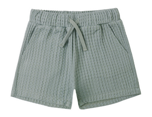 The Boys' Relaxed Short by Rylee & Cru features a light green color, soft fabric, elastic waistband with adjustable drawstring, and two side pockets, shown on a white background.