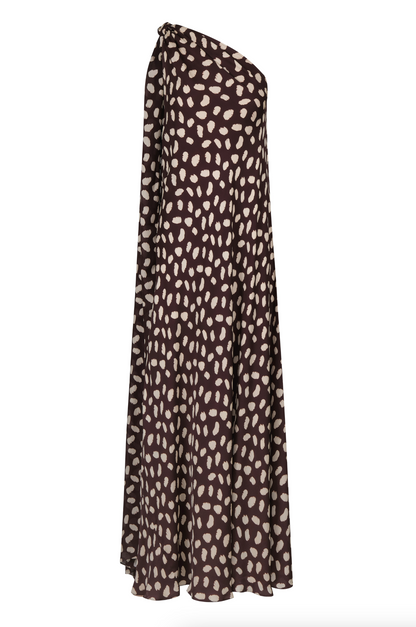 The Johanna Ortiz Silk Elegant Freedom Maxi Dress is a black, ankle-length, one-shoulder silk dress with a loose fit and white irregular dot pattern—perfect for an elegant evening.