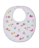 The Kissy Kissy Ocean Antics Printed Bib features a white base with pink trim, made from the softest cotton for ultimate comfort, and is decorated with colorful prints of sea creatures such as whales, octopuses, turtles, fish, and starfish.
