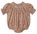 The Noralee Baby Girls' Maddie Romper features a vintage-inspired pink and beige floral print, crafted from swiss dot fabric with a smocked neckline, plus elasticated cuffs and leg openings.