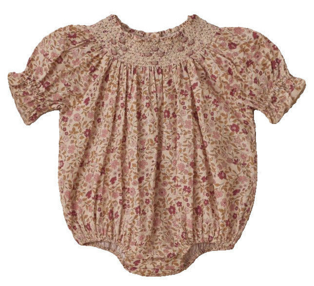 The Noralee Baby Girls' Maddie Romper features a vintage-inspired pink and beige floral print, crafted from swiss dot fabric with a smocked neckline, plus elasticated cuffs and leg openings.
