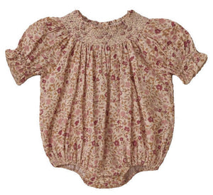 The Noralee Baby Girls' Maddie Romper features a vintage-inspired pink and beige floral print, crafted from swiss dot fabric with a smocked neckline, plus elasticated cuffs and leg openings.