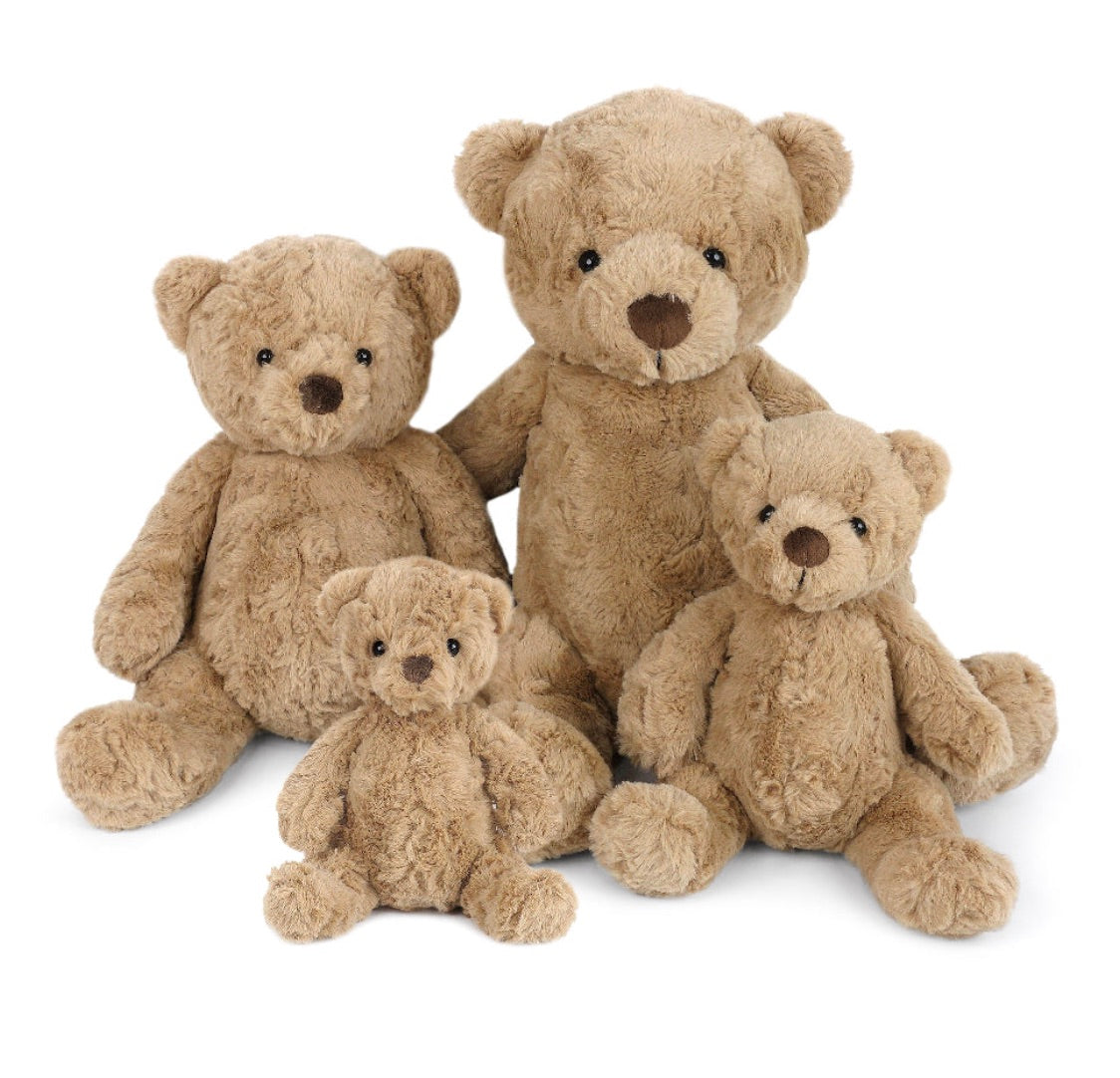 Four brown Huggie Bear plush teddy bears by Mon Ami, in varying sizes, are seated together against a white background, ready to offer cozy cuddles with their ultra-soft fur.