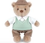 Bogey Golf Bear by Mon Ami stands upright against a white background, dressed in a brown cap, green sweater vest over a white shirt, and brown pants—this cuddly stuffed animal adds charming country-club style to any collection.