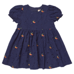 The Girls' Eliza Eyelet Embroidery Dress from Pink Chicken is a navy blue short-sleeve dress adorned with delicate eyelet embroidery and small orange floral patterns. Featuring puffed sleeves and a gathered skirt, this charming style offers cheerful elegance for any occasion, making it the perfect girls' fall dress inspired by classic silhouettes.