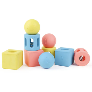 The Hape Geometric Rattle Trio features pastel foam blocks and balls, some with holes and bells inside—perfect for developing hand-eye coordination in young learners.