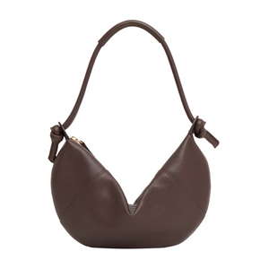 The Mini Fortuna Bag by Mansur Gavriel, made from premium calf leather, showcases a rounded shape, short handle, and knotted side details, presented against a plain white background.