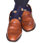 A person wearing brown leather loafers and Dapper Classics Beer Mid Calf Socks, featuring a beer mug pattern, with pants visible at the top.