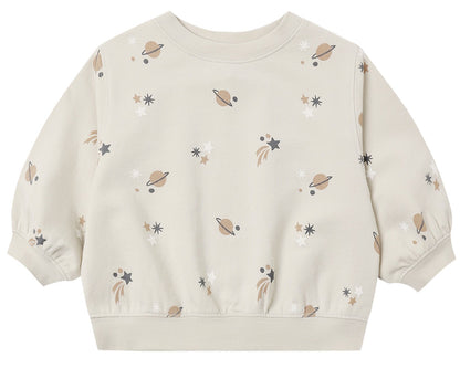 The Quincy Mae Baby Boys’ and Boys’ Oversized Crew Sweatshirt features a neutral beige color with an all-over pattern of planets, stars, and shooting stars in soft shades. Made from cozy fleece, this oversized crewneck pullover showcases the whimsical design across the front, sleeves, and back—making it an ideal layering piece for any adventure.