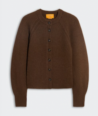 The Sculpted Cardigan by Guest in Residence is a brown, long-sleeve cashmere sweater with ribbed cuffs and hem and a classic button-up design, shown on a plain light background.