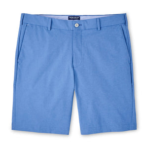 The Peter Millar Surge Performance Short in light blue features belt loops, a front button, zip fly, side pockets, and four-way stretch for comfort. Perfect men's performance apparel, shown laid flat on a white background.