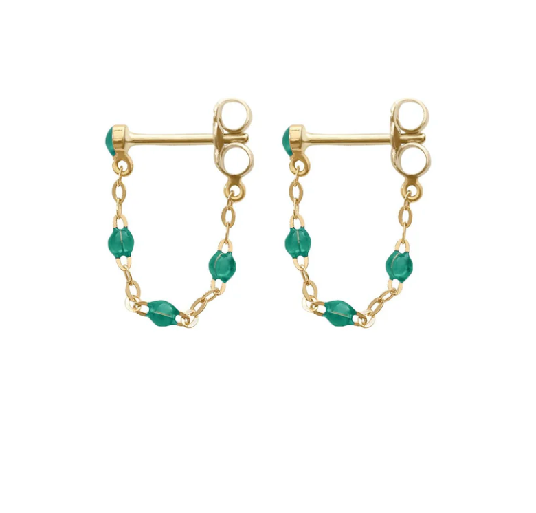 Explore the exquisite Gigi Clozeau Classic Gigi Earrings, showcasing gold studs with connecting chains and small green beads, a testament to Gigi Clozeau's jewelry artistry.