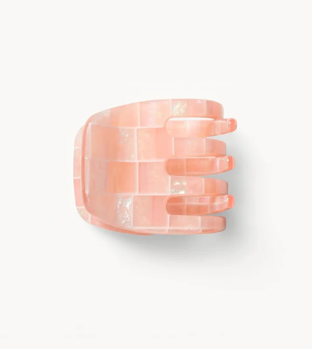 The Machete Mini Claw, a pink rectangular-patterned hair clip with four prongs, is handcrafted from bio-acetate and displayed on a plain white background.