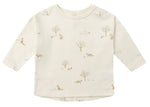 The Quincy Mae Baby Long Sleeve Tee is made from cream-colored organic brushed cotton and features all-over light brown animal and tree prints.