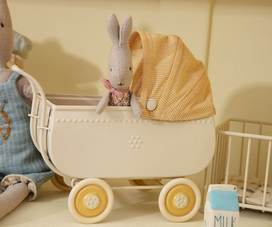 A Maileg My Rabbit, Rose in a stroller with a cute bow.