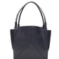 The Small Victoria Tote by Victoria Beckham, crafted in smooth navy calf leather with double handles, simple stitching, and a geometric front panel design, is shown against a white background.