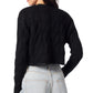 A person wearing a Sablyn Jolie V-Neck Cropped Cable Cardigan in black and light blue jeans, viewed from behind.