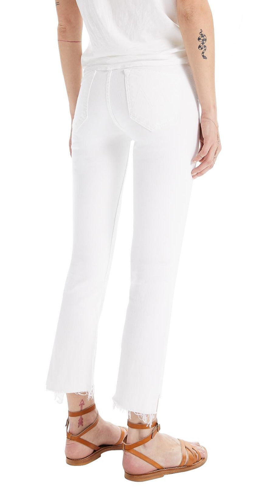 The woman is wearing Mother white jeans with a frayed hem.