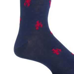 A close-up of the Dapper Classics Red Lobster Cotton Mid-Calf Sock, featuring red embroidered lobster motifs on navy blue, crafted from breathable cotton for comfort.