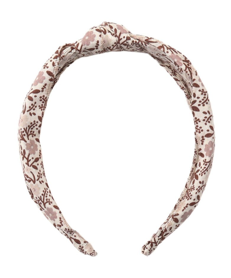The Girls’ Knotted Headband by Rylee & Cru, designed with a brown and light pink floral pattern on a beige fabric, offers both style and comfort and is shown on a white background.