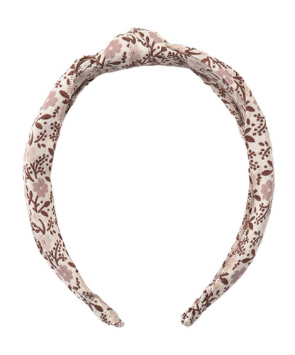 The Girls’ Knotted Headband by Rylee & Cru, designed with a brown and light pink floral pattern on a beige fabric, offers both style and comfort and is shown on a white background.