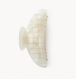 The Machete Midi Heirloom Claw, crafted from Italian acetate in a white iridescent grid pattern, is displayed against a plain white background.