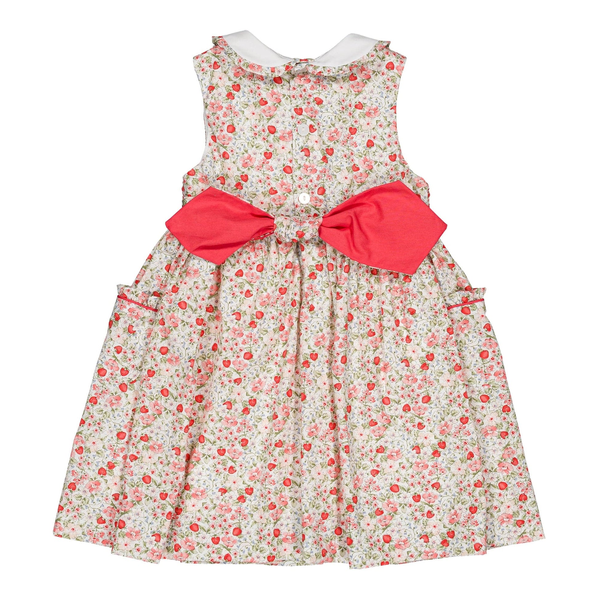 The Kidiwi Baby Girls' and Girls' Ixia Smocked Dress features a sleeveless cotton design with a white collar, front buttons, two side pockets, and a large pink bow tied at the back.
