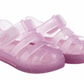The Igor Girls' Star Jelly Sandal features translucent pink PVC with glitter and Velcro straps, shown side by side.
