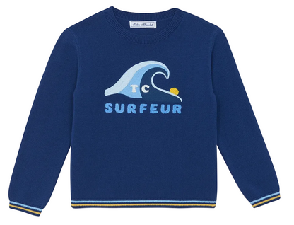 The Boys’ Illustration Sweater by Tartine et Chocolat features a blue design with a wave graphic, a yellow sun, and the word “SURFEUR” printed on the front. Crafted from 100% cotton, this long-sleeve sweater is finished with yellow and white striped detailing on the cuffs and hem.