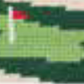 A pixelated golf course hole on the Golfer's Camo Belt by Smathers & Branson showcases a vibrant green with a red flag, echoing the intricate craftsmanship of needlepoint design.