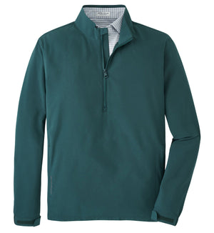 The Peter Millar Dunes Half-Zip is a teal pullover made from four-way stretch performance fabric, featuring a stand collar and long sleeves, shown against a white background.