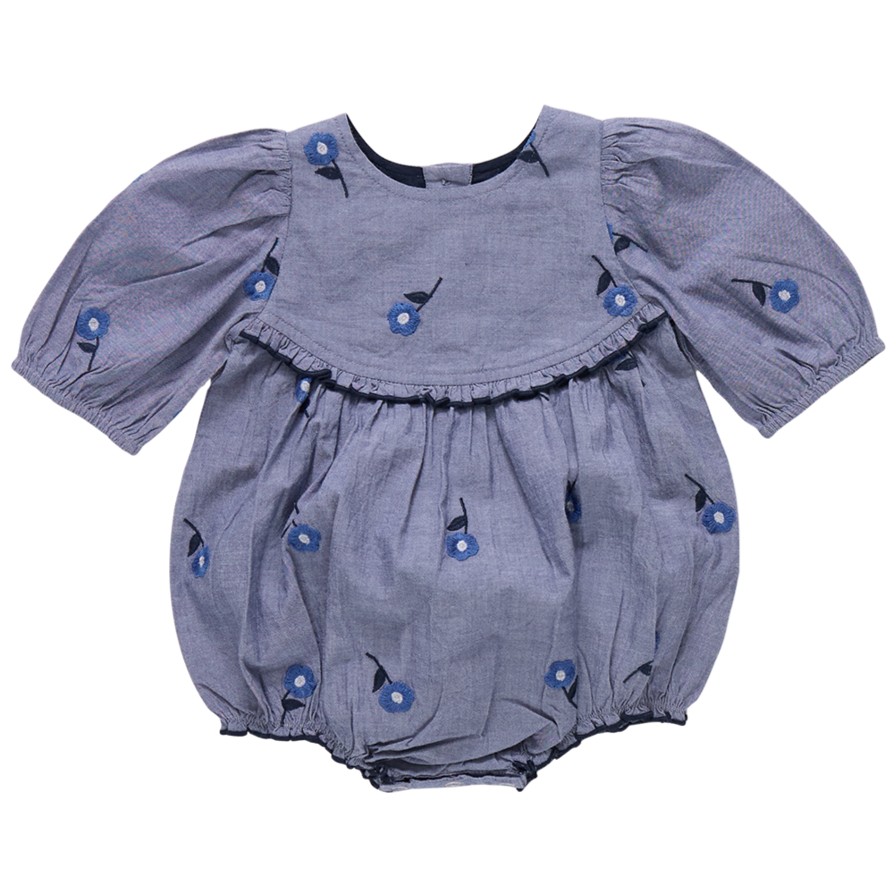 The Pink Chicken Baby Girls' Rowan Bubble, featuring puffed sleeves, floral print, blue blossom embroidery, and chest ruffle detail, is shown on a plain background.