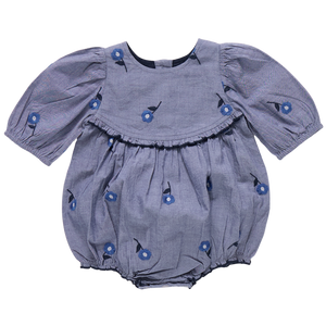 The Pink Chicken Baby Girls' Rowan Bubble, featuring puffed sleeves, floral print, blue blossom embroidery, and chest ruffle detail, is shown on a plain background.