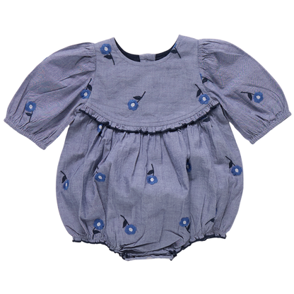 The Pink Chicken Baby Girls' Rowan Bubble, featuring puffed sleeves, floral print, blue blossom embroidery, and chest ruffle detail, is shown on a plain background.