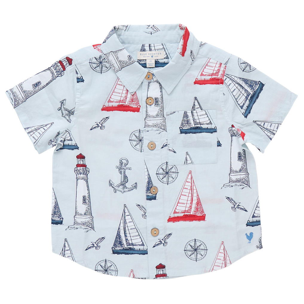 Pink Chicken Boys' Jack Shirt with a nautical print—sailboats, lighthouses, anchors, compasses, and seagulls in red and blue. Perfect short-sleeve shirt for little sailors' nautical adventures.