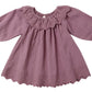The Quincy Mae Baby Girls' and Girls' Long Sleeve Isla Dress in mauve features a scalloped hem and embroidered details on the collar and bottom edge. Made from soft cotton, it's perfect for stylish comfort.