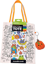 Crocodile Creek Color Your Own Trick or Treat Bag featuring a festive print, orange striped handles, and a pumpkin-shaped LED keychain.