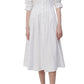 A woman in a white Simkhai Signature Jazz dress with a button-up closure.