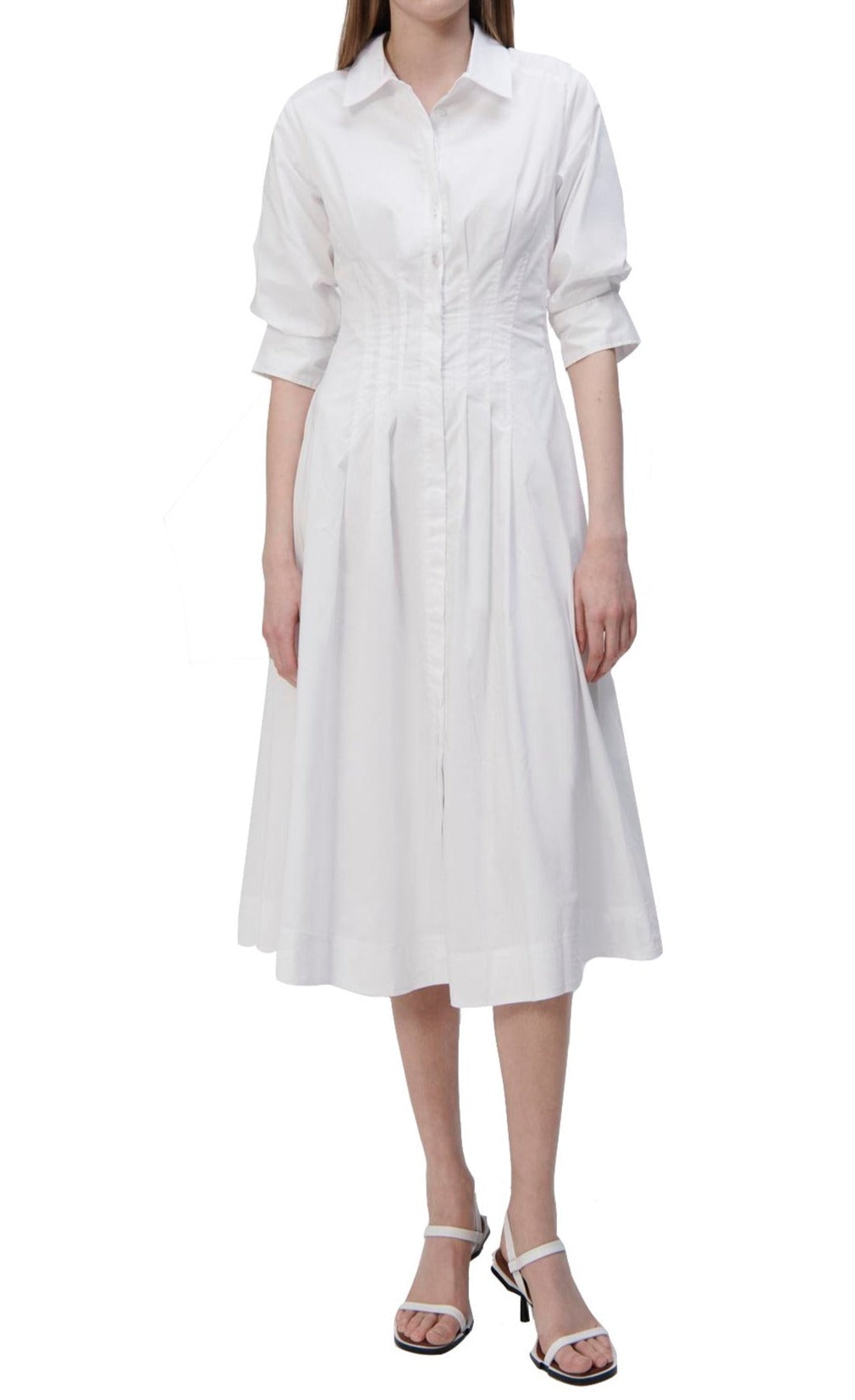 A woman in a white Simkhai Signature Jazz dress with a button-up closure.